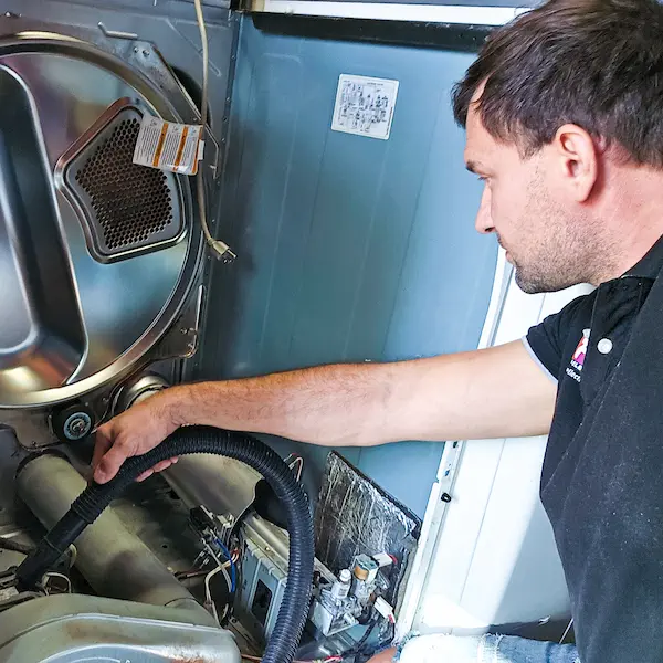 Dryer Repair Services Los Angeles - technician repairing a dryer