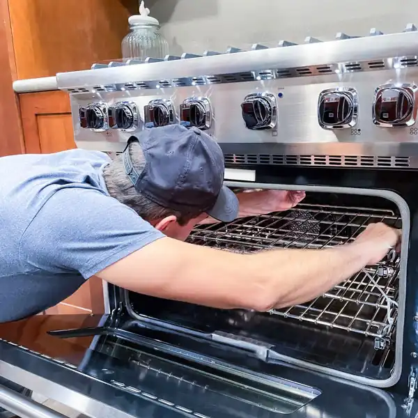 Oven Repair Services Los Angeles - technician repairing an oven